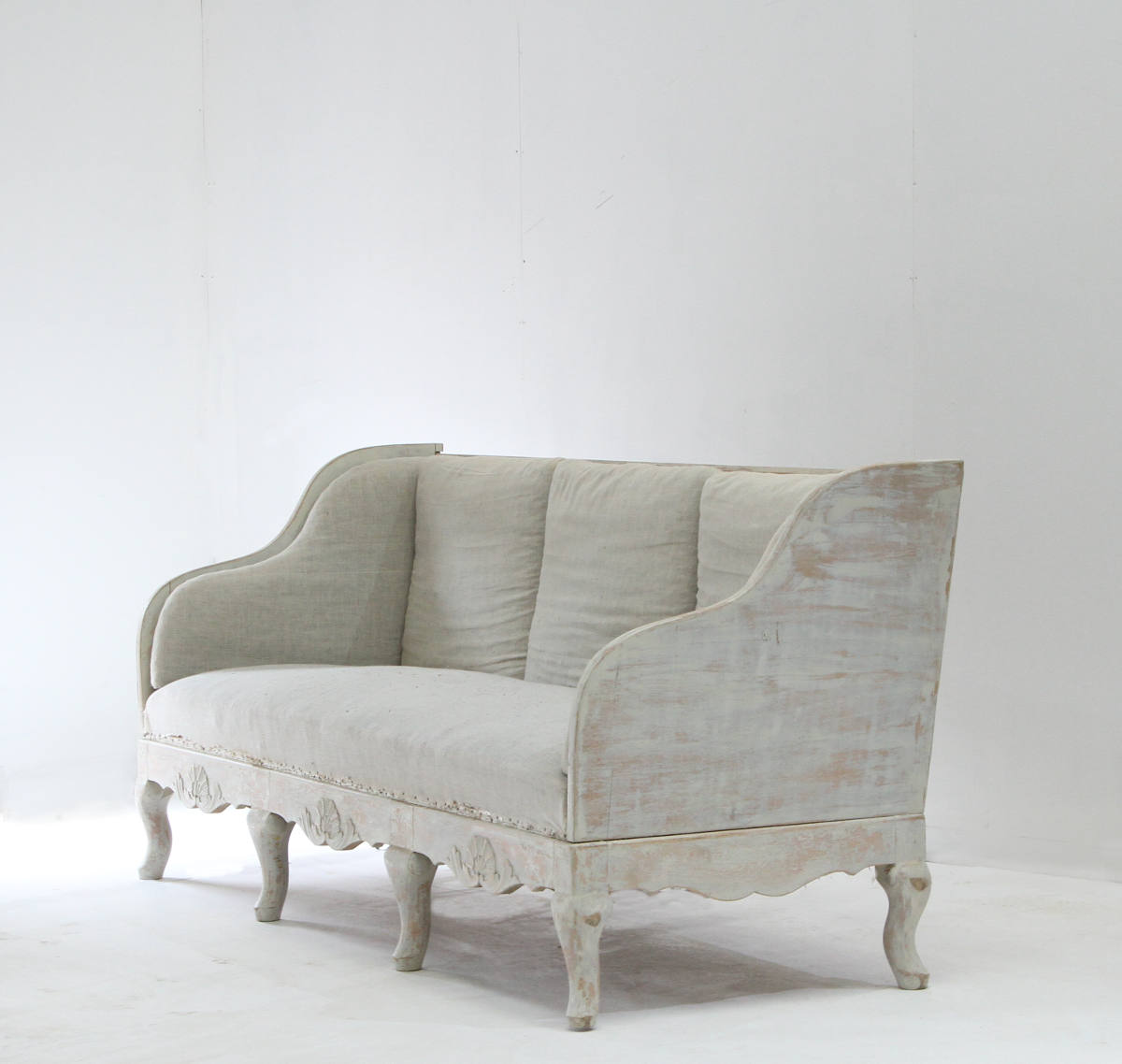 A stylish Swedish rococo style sofa with carved detail on the base