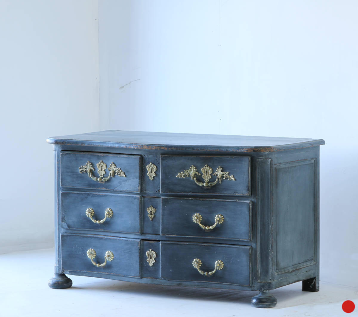 An early 18c serpentine commode in a rich blue colour with its original hardware