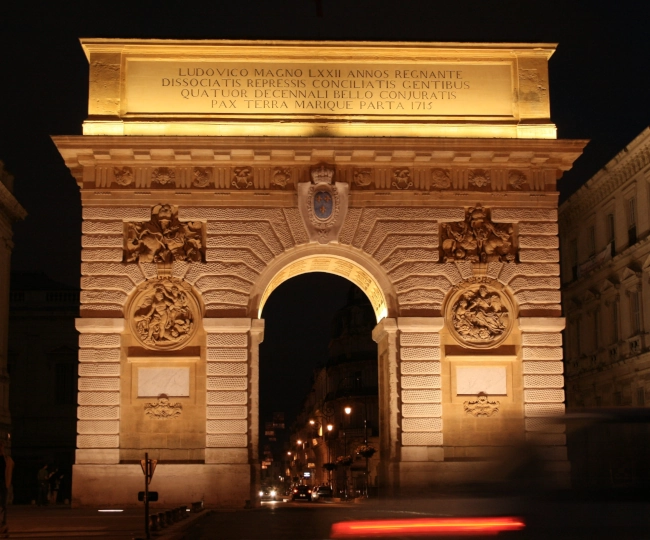 A stunning city arch in Montpellier at night