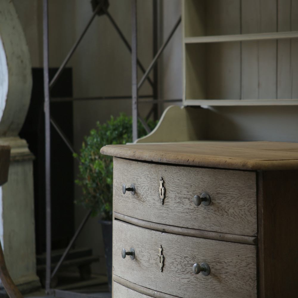 A close up side view of the top two drawers showing the bow front