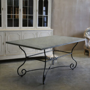 A striking decorative stone top table on a wrought iron base